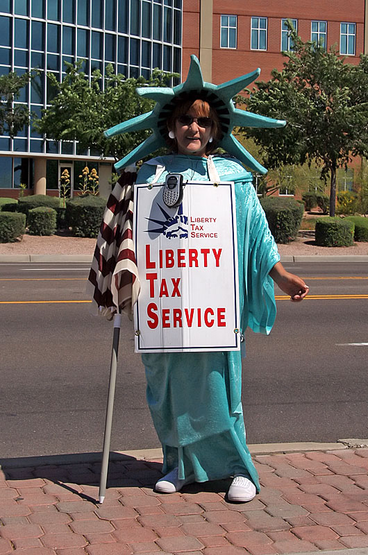 Princess Liberty standing on the streets of Phoenix, Arizona offering tax preperation services