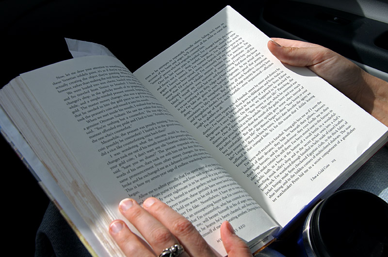 Caroline has the book, "Ny Name is Red" open in her lap as she reads to me on the way to work