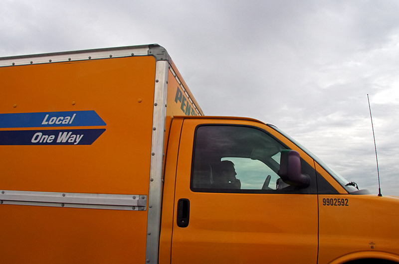 Idiot in a moving van speeding while swerving in and out of lanes talking on his cell phone at the same time