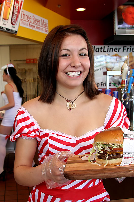 Counter help delivering a single bypass burger on the Valentines Day Massacre all-you-can-eat for free day at the Heart Attack Grill in Tempe, Arizona