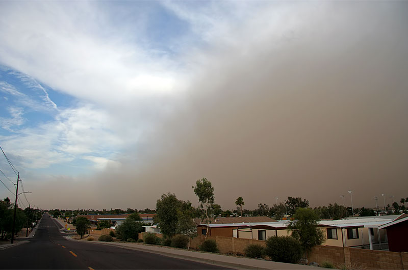 A large dust storm blew into Phoenix, Arizona today. In this photo you can see the giant wall of sand contrasted against the blue cloudy sky