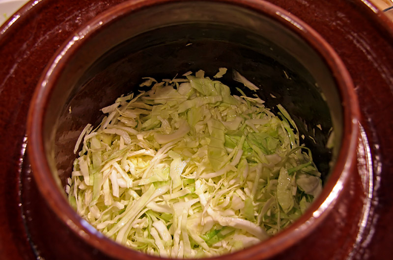 A crock of Sauerkraut being prepared