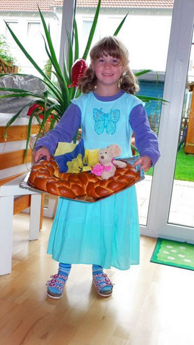 Katharina holding a braided bread in Germany