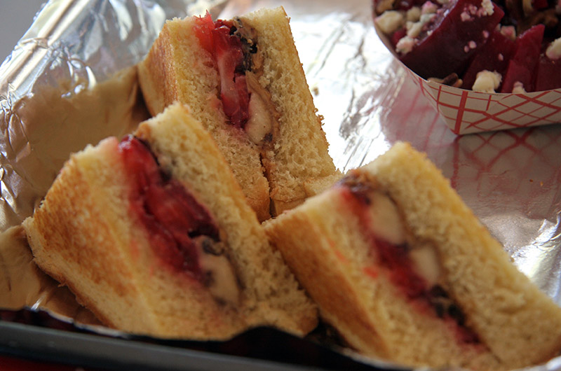 A grilled peanut butter, fresh strawberry and banana, pineapple, and chocolate chip sandwich