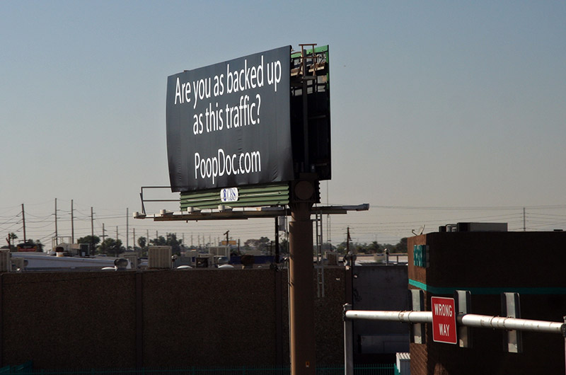 Just in the nick of time, I snapped this while on a freeway overpass, a billboard asking "Are you as backed up as this traffic? PoopDoc.com", Phoenix, Arizona