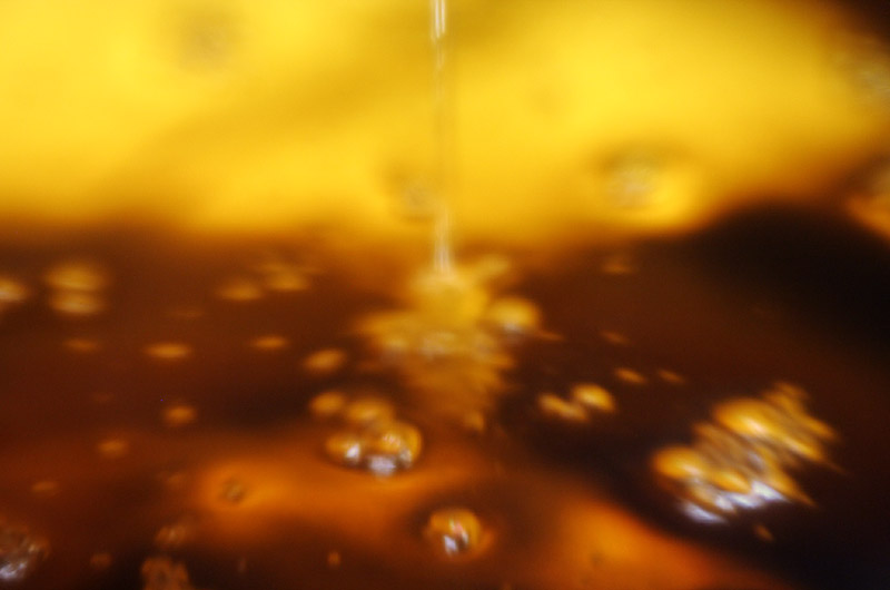 Limoncello after removing the lemon peel dripping through a coffee filter awaiting the addition of syrup before finally becoming Limoncello