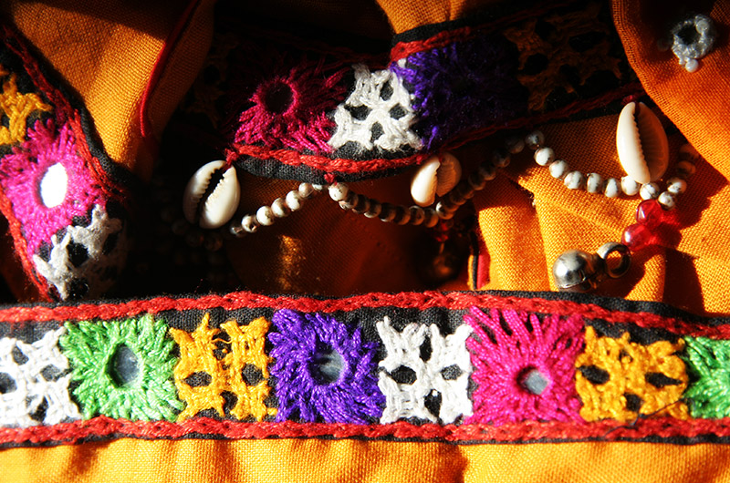 Indian dress glowing orange with bright colors illuminated by the rising morning sun