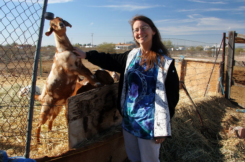 Caroline Wise and a goat at Chile Acres Farm in Tonopah, Arizona