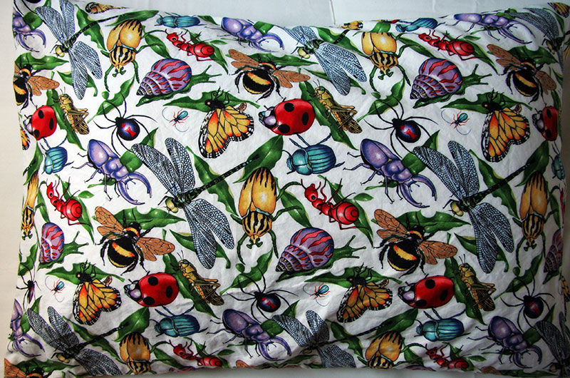 My pillow case covered with a colorful insect pattern handmade by my wife