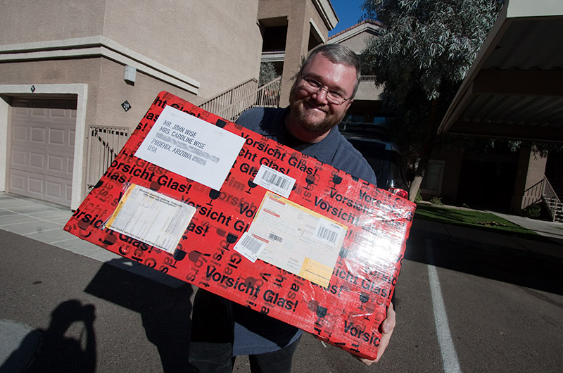 John Wise holding a package from friends in Berlin, Germany