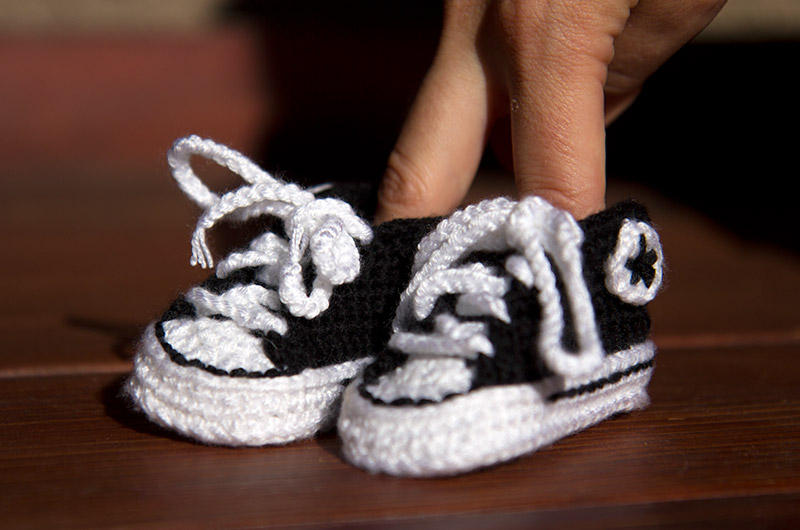 Hand crocheted Converse black and white baby shoes made by Caroline Wise