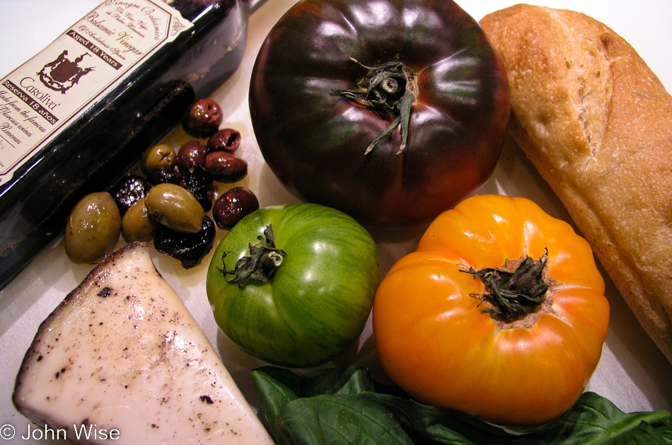 Heirloom tomatoes, anise and truffle cheese called Caesaria Sottocenere, Caroliva 18-year-old Balsamic Vinegar, olives and bread