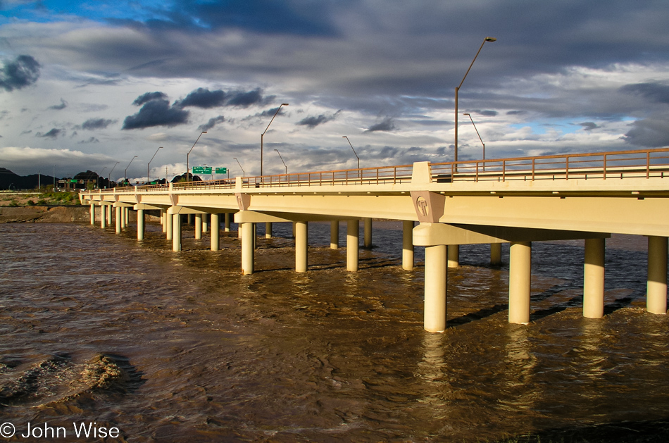 The Salt River slicing through Phoenix, Arizona normally is a dry river bed due to upstream dams, but after a very wet winter an 8 foot depth of water runs from bank to bank