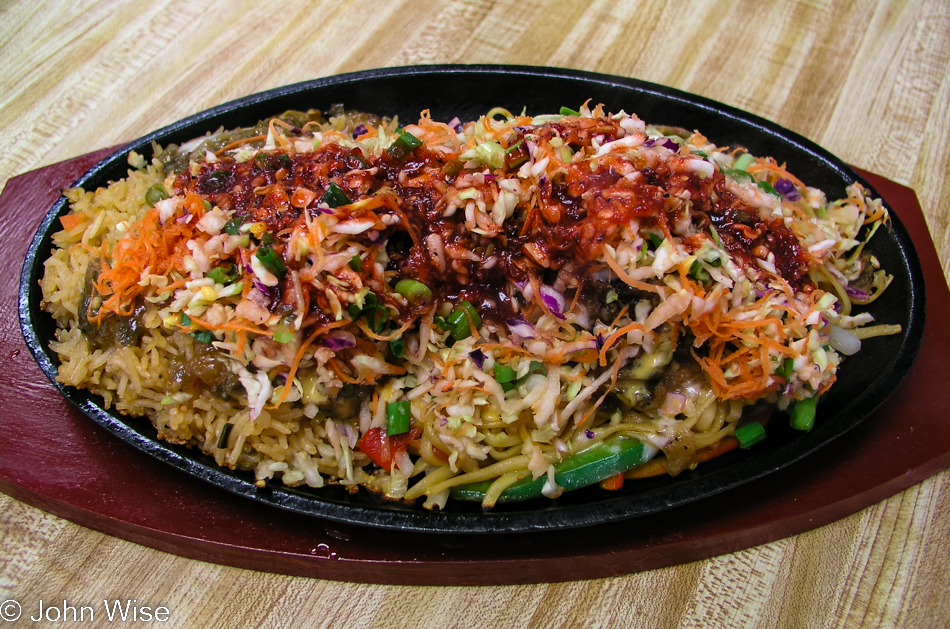 A sizzling plate of Indo-Chinese veggies, rice, and noodles called Manchurian Sizzler at RasRaj in Artesia, California