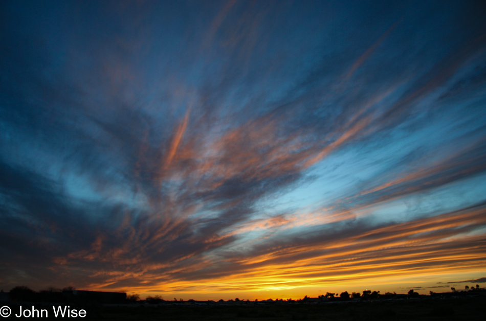 Molten orange and electic pink in front of a cold blue fading sky at sunset in Phoenix, Arizona