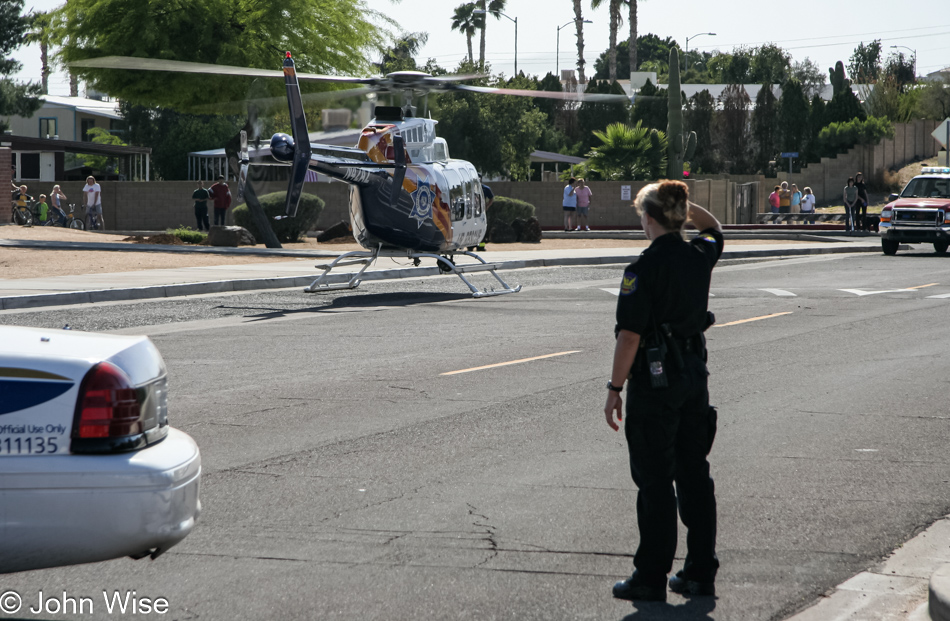 Police create a barrier between public and helicopter during drowning rescue in Phoenix, Arizona