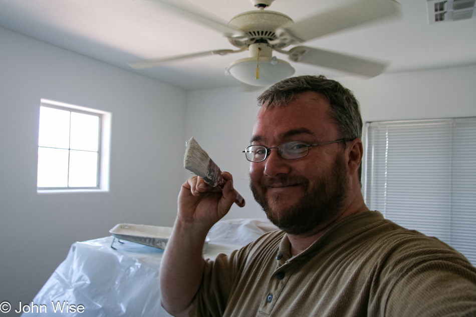 John Wise helping paint a house in Scottsdale, Arizona