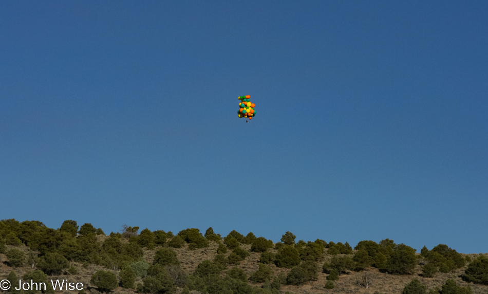 Man sitting under a bunch of balloons near Panguitch, Utah