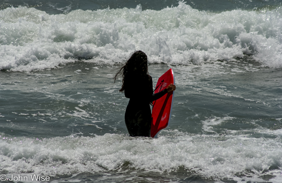 Woman entering the surf near Carpenteria, California