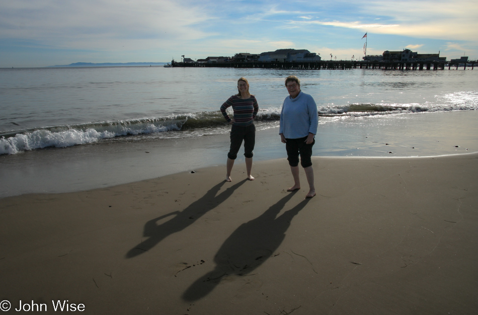 Caroline Wise and Jutta Engelhardt walking in the surf on Christmas day in Santa Barbara, California