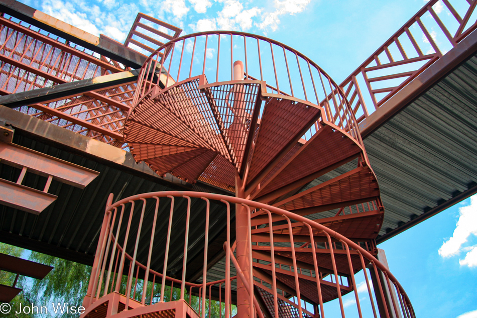 Spiral staircase next to a long ramp for accessing a pedestrian overpass that I have never seen used here in Phoenix, Arizona