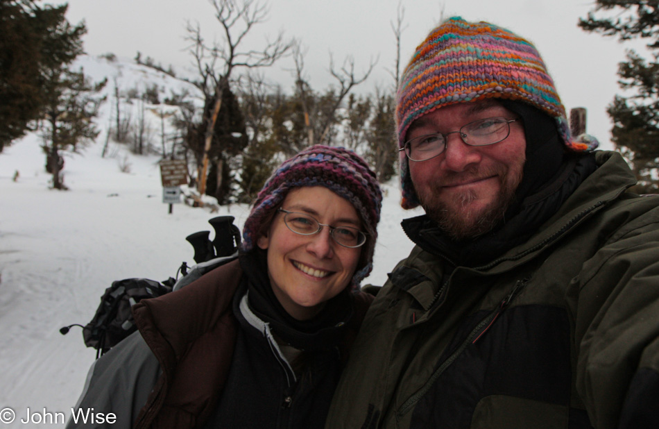 Caroline Wise and John Wise on the Upper Terrace at Mammoth Hot Springs in Yellowstone National Park during a gray winter day