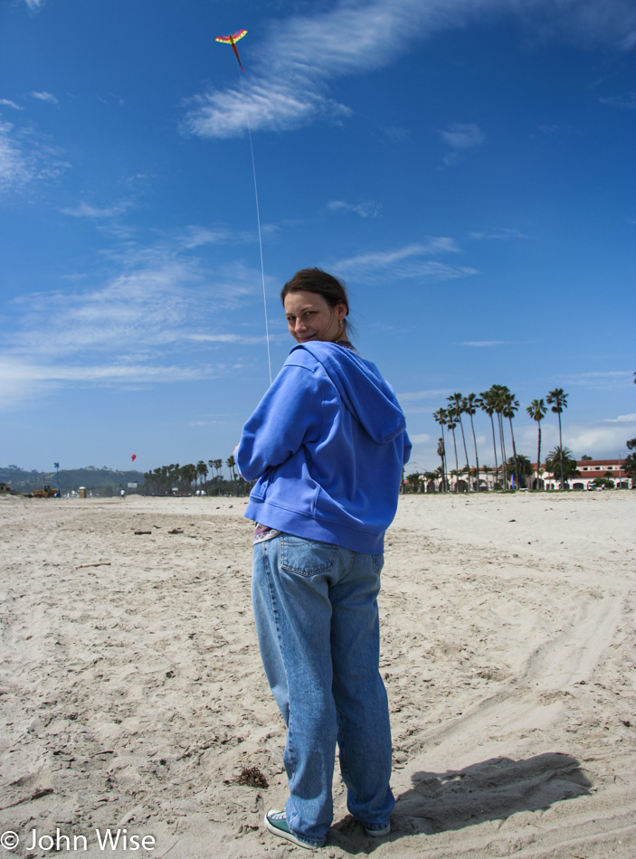 Caroine Wise flying her kite on a beach in Santa Barbara California