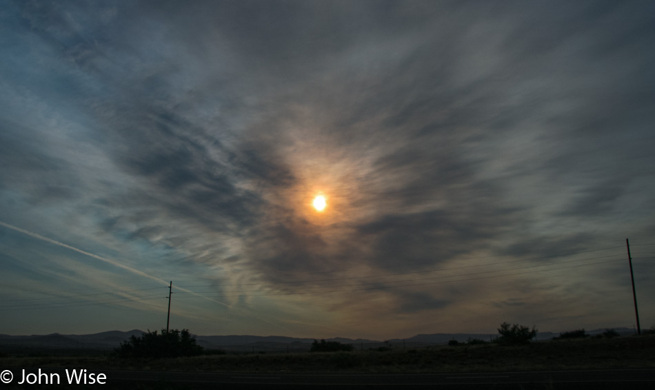 Smoke from recent forest fires obscures the sun producing a burnt orange haze