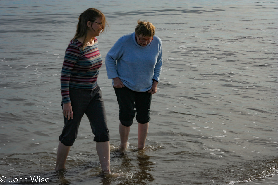 Caroline Wise and Jutta Engelhardt walking in the surf on Christmas day in Santa Barbara, California