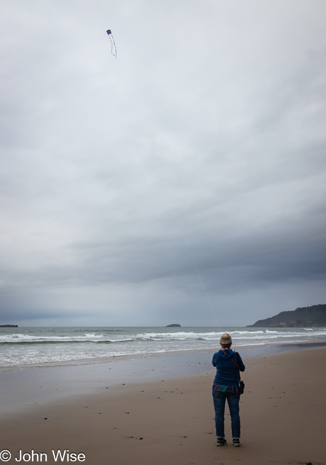 Caroline Wise flying her kite near Wade Creek on Moolack Beach in Newport, Oregon