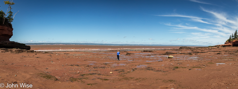 Caroline Wise standing on sea floor of Bay of Fundy at Burntcoat Park in Noel, Nova Scotia, Canada