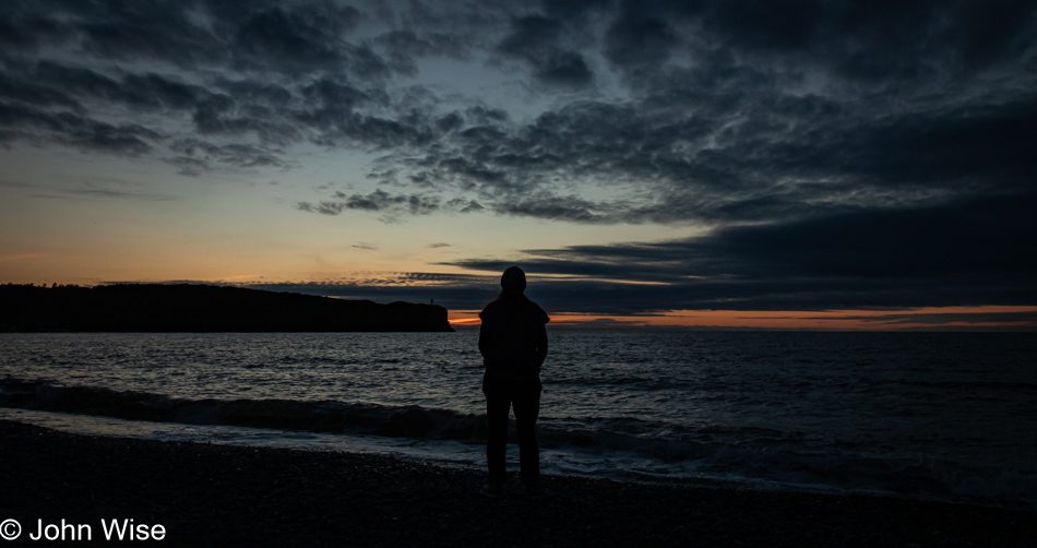 Caroline Wise on the shore at sunset in Trout River, Newfoundland, Canada